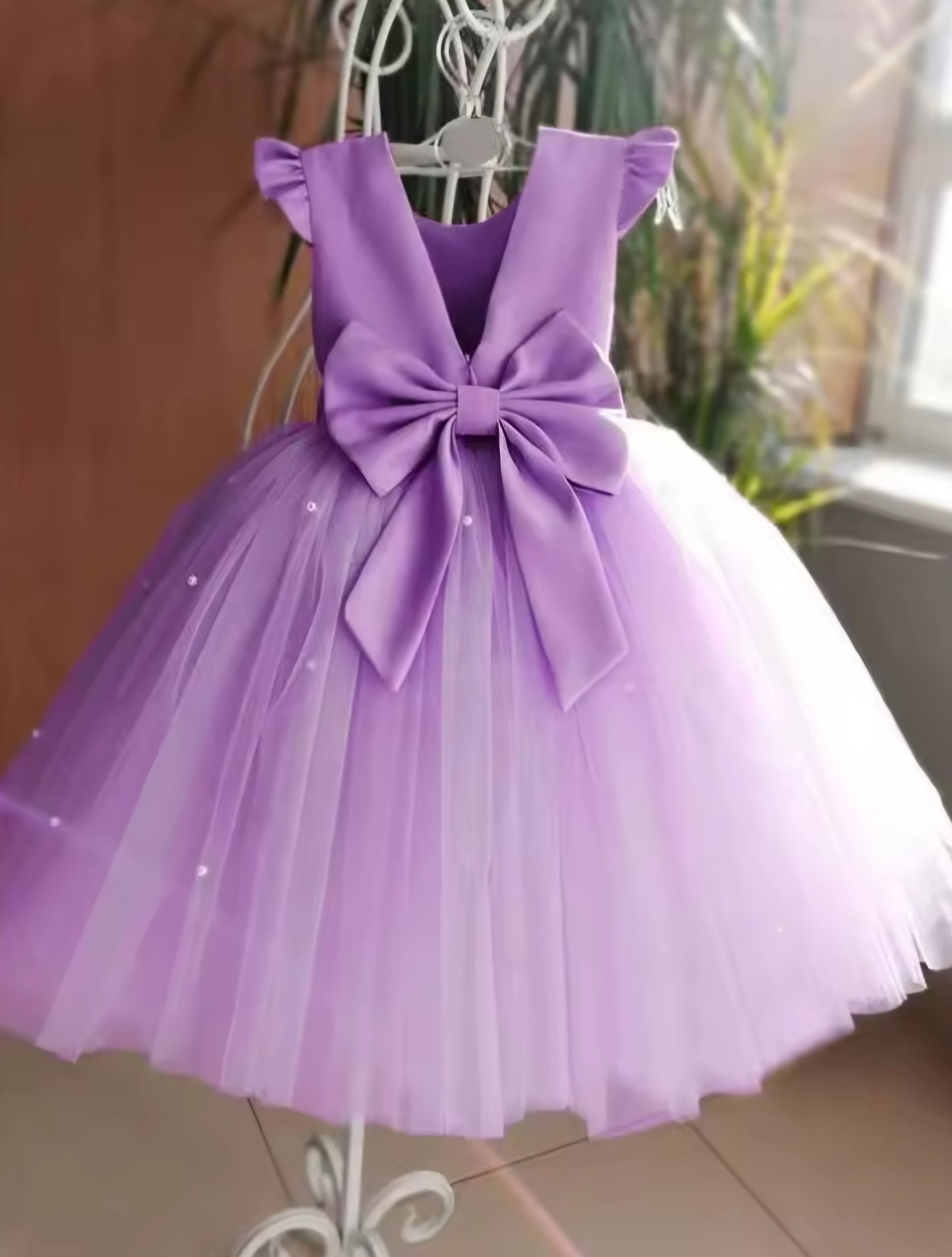 Vestido lila, perlas, moño