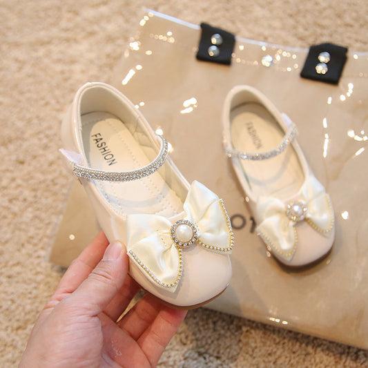 Calzado beige, perlas, moño
